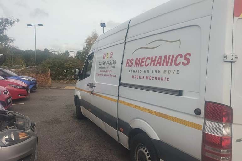 The RS Mechanics van parked alongside a customer's car during an on-site repair